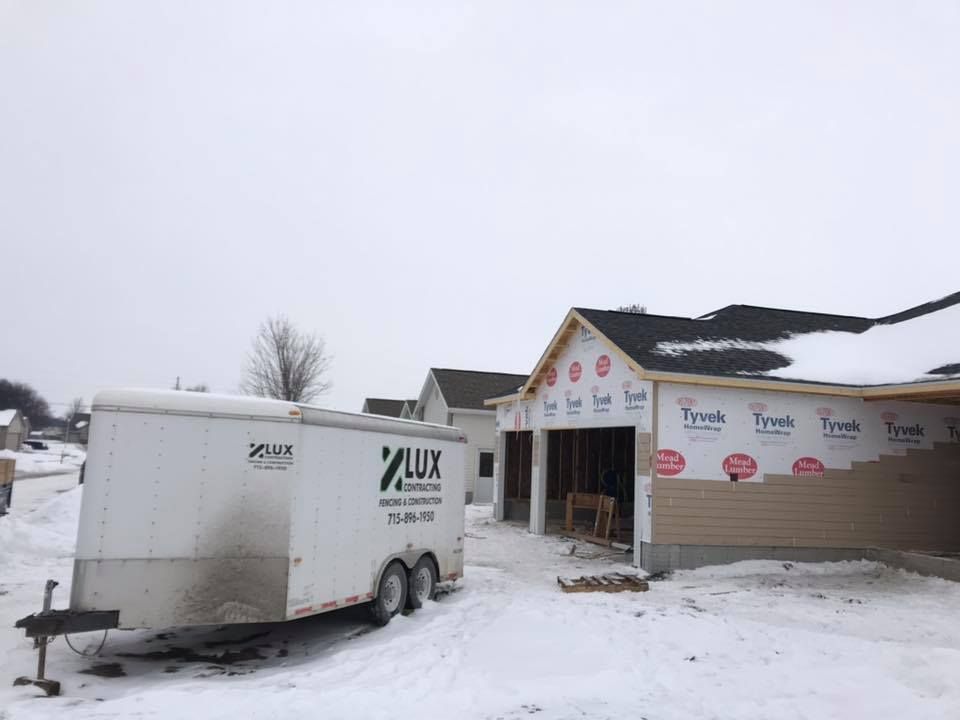 A man wearing a hard hat and goggles is standing in a room.