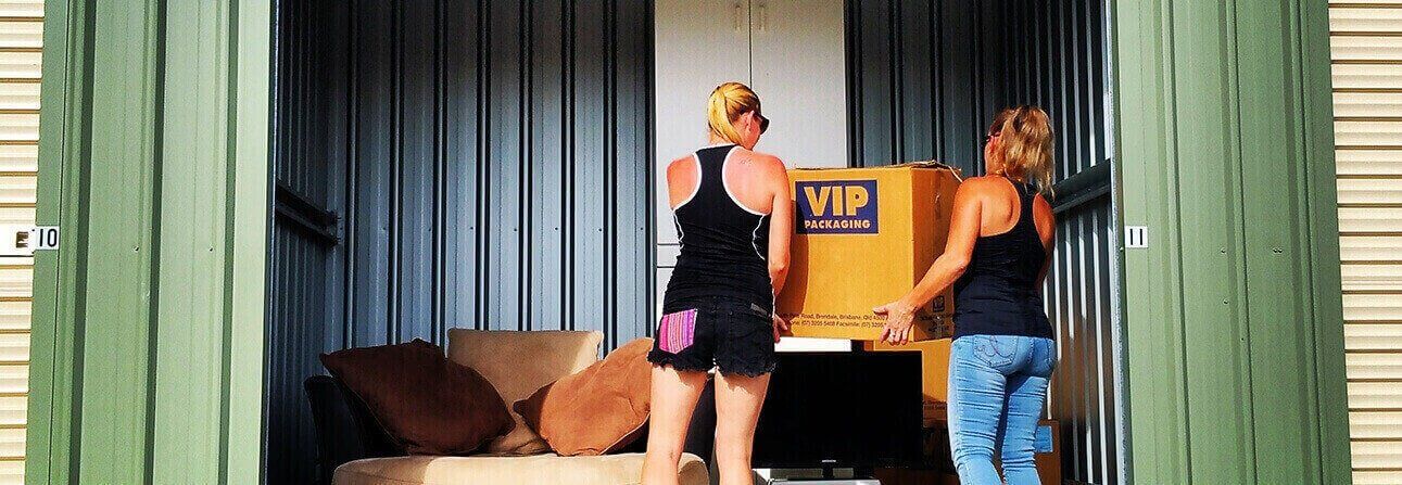 Two Women Carrying A Box — Storage Solutions in Pottsville, NSW