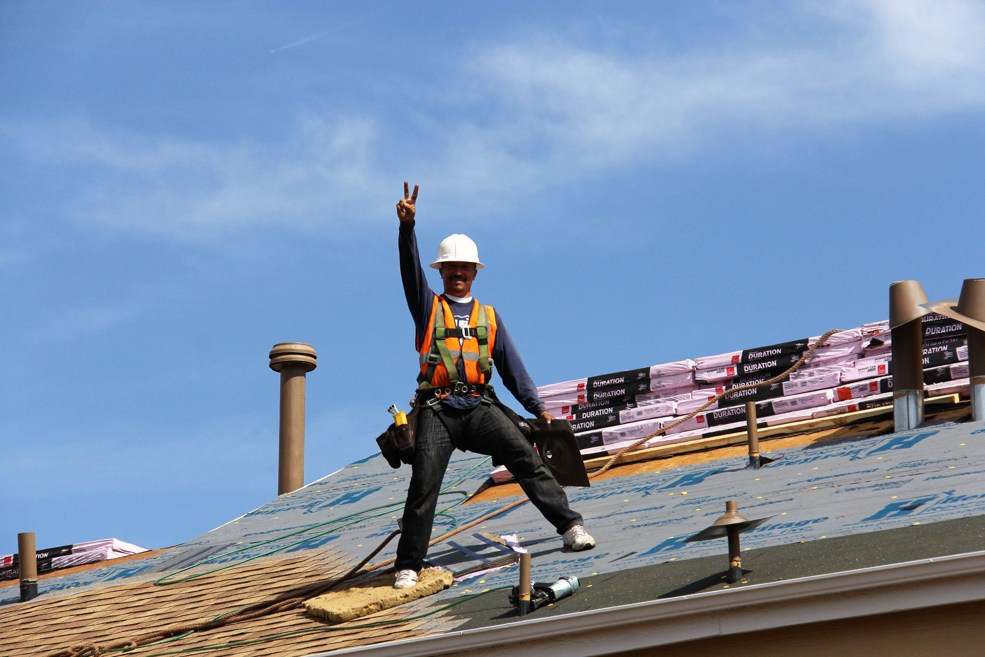 A member of the crew takes a moment on a roof to engage the camera.