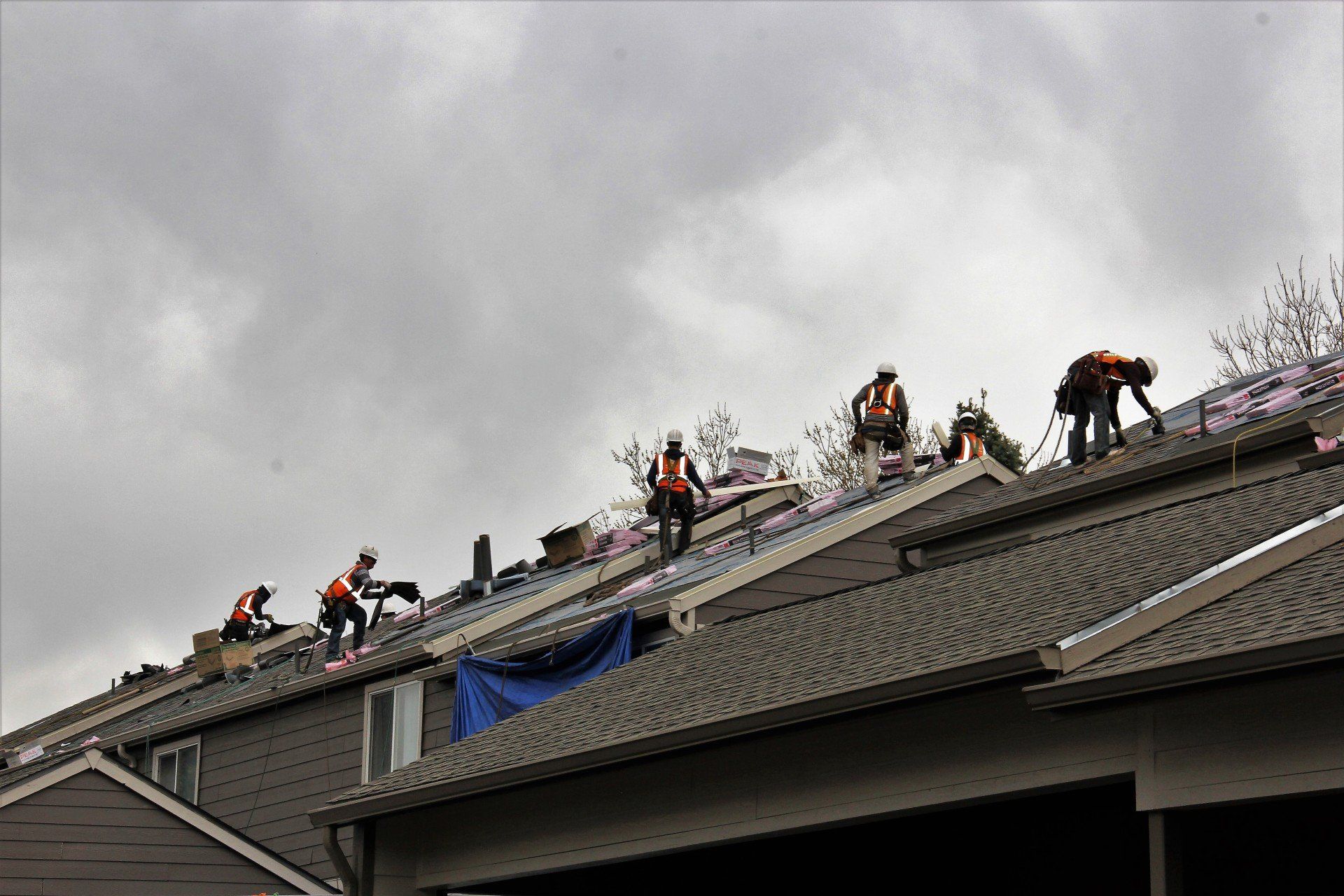 A team of roofing workers are installing a new roof.