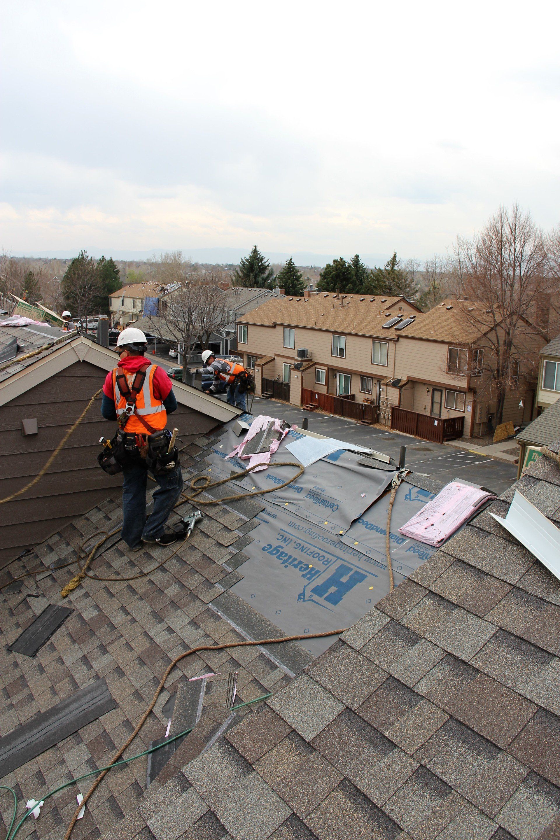 The crew is in the final moments of installing a new roof.