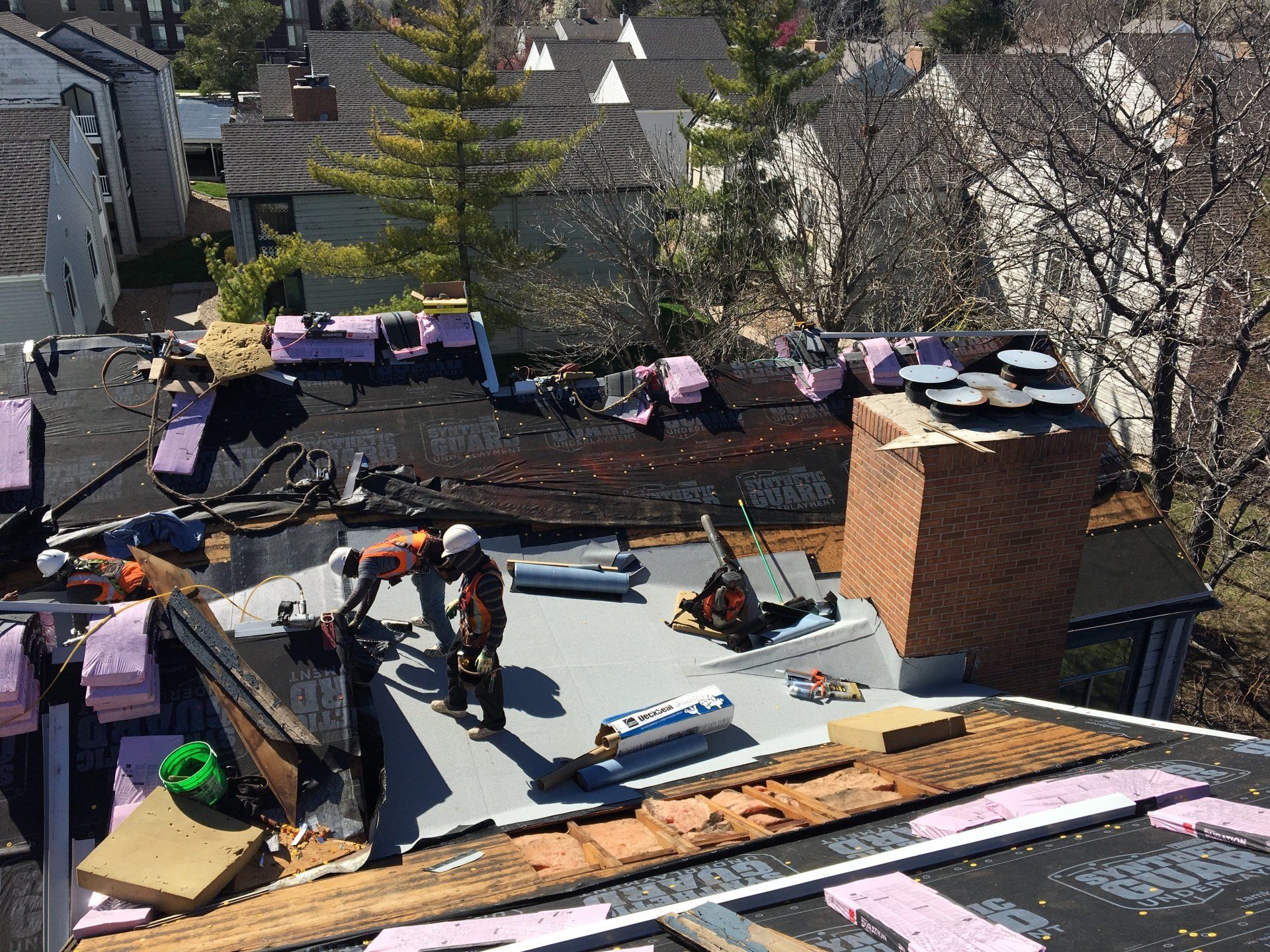 The crew has the materials and tools they need for a new roof installation.