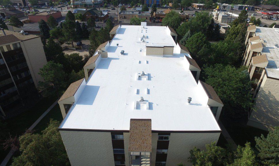 An aerial view of a freshly coated flat roof.