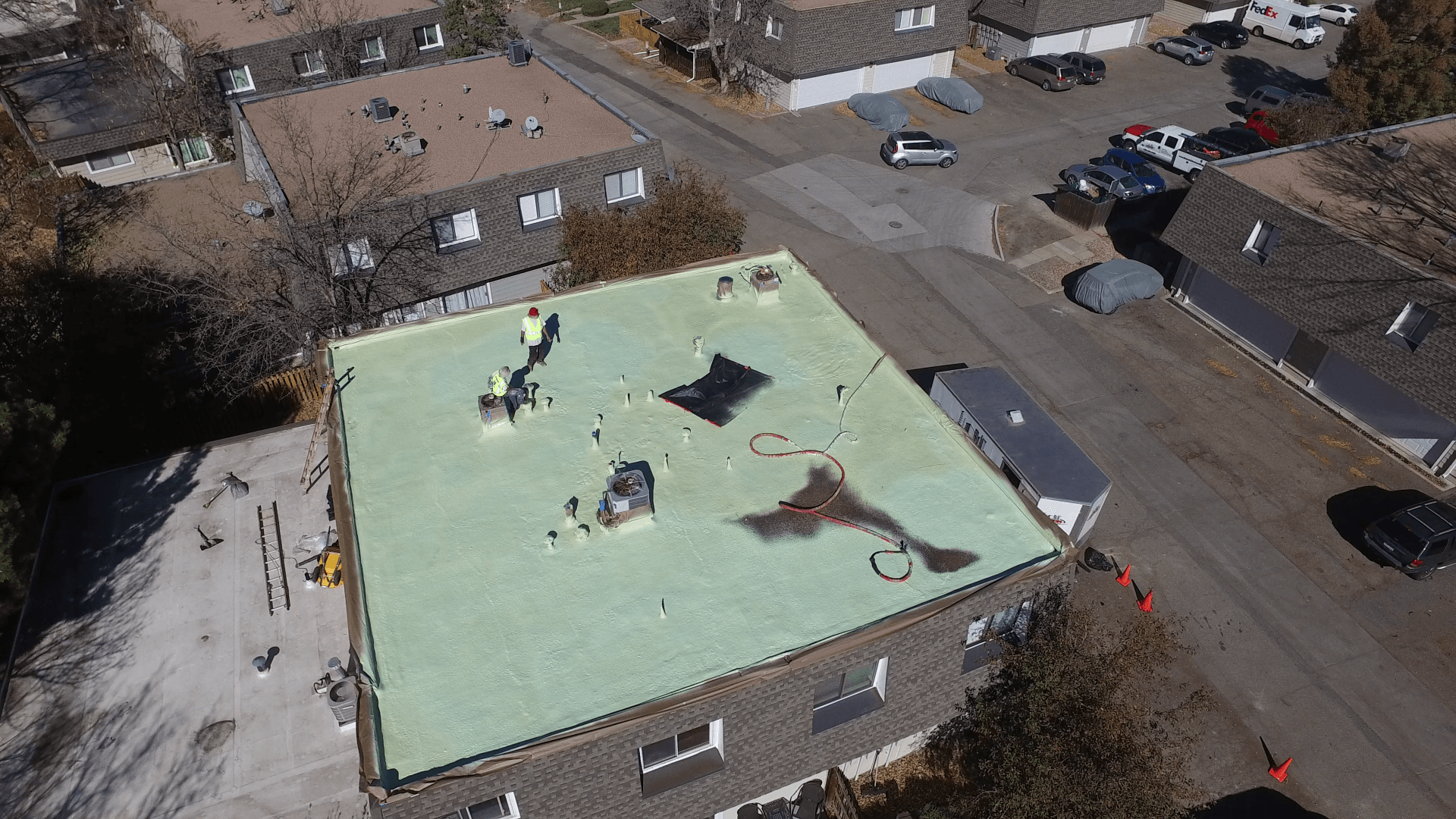 An aerial view of a coating in the final stages for a flat roof.