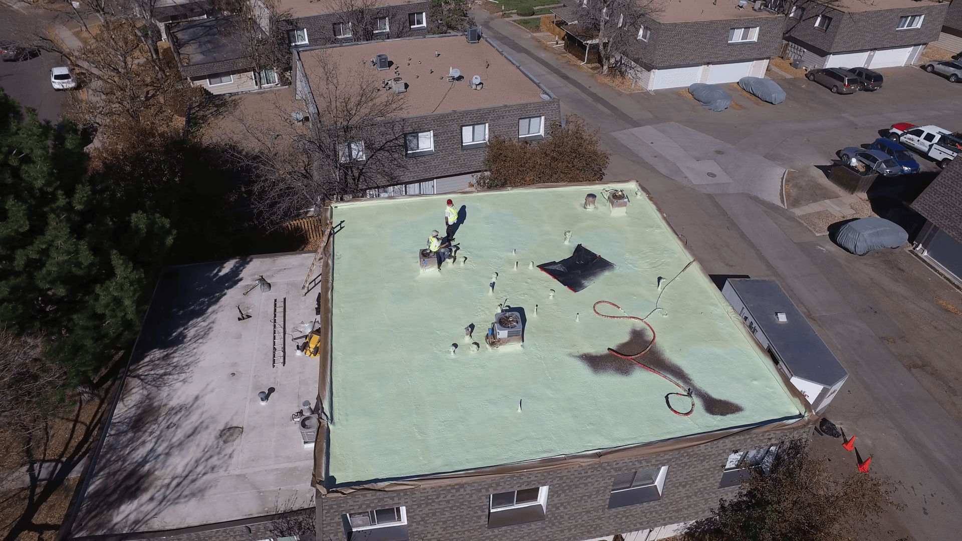 A flat roof is in the process of getting coated.