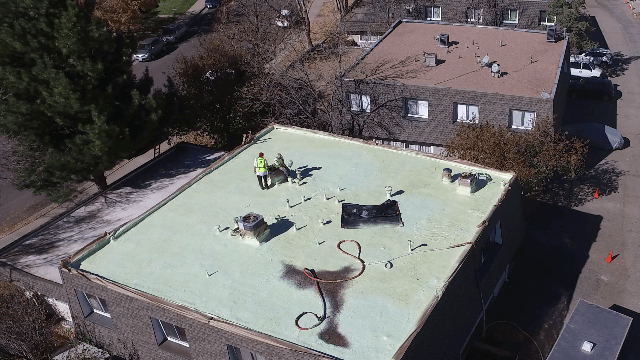 An aerial view of roof coating job in the final stages.