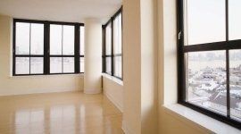 Stanza vuota con ampie finestre, infissi neri in pvc