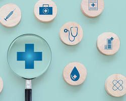 Magnifying glass over blue cross, surrounded by health icons on wooden circles, light blue background.