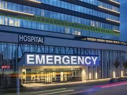 A hospital with a sign that says emergency on it.