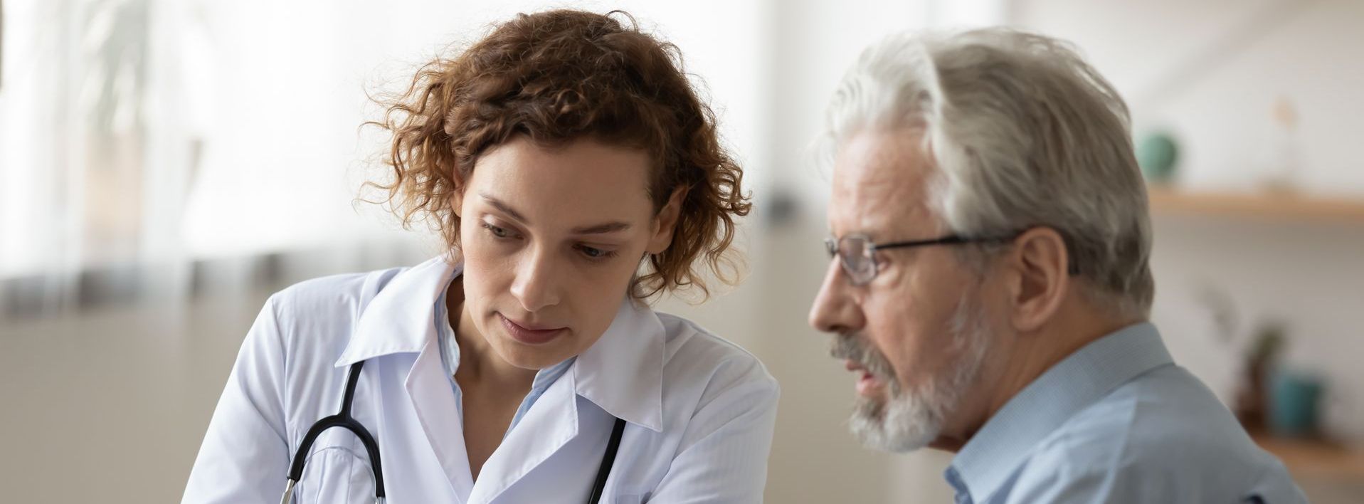 a woman is giving a presentation to a group of people sitting around a table .