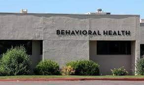 a behavioral health building with a sign on the side of it .