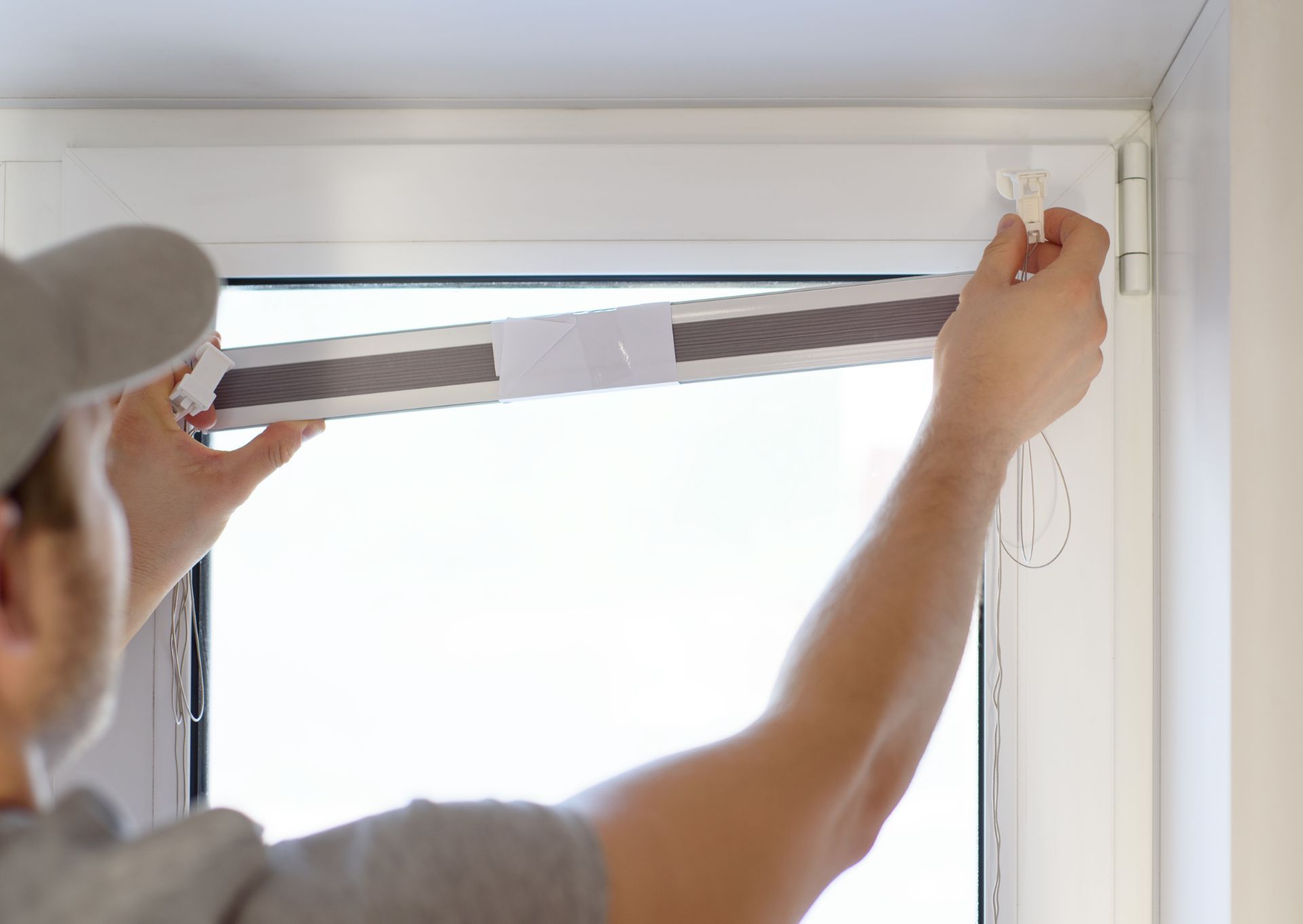 Worker replacing window treatment