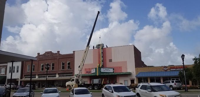 A crane is working on a building in a small town.