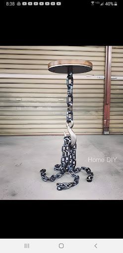 A table made out of chains and a wooden stool.