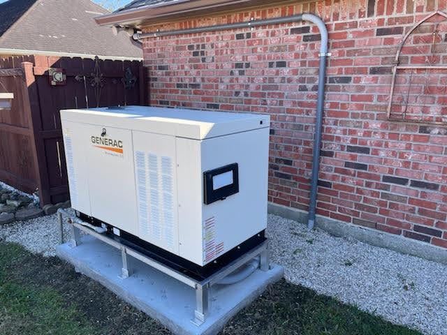 A generator is sitting outside of a brick house.