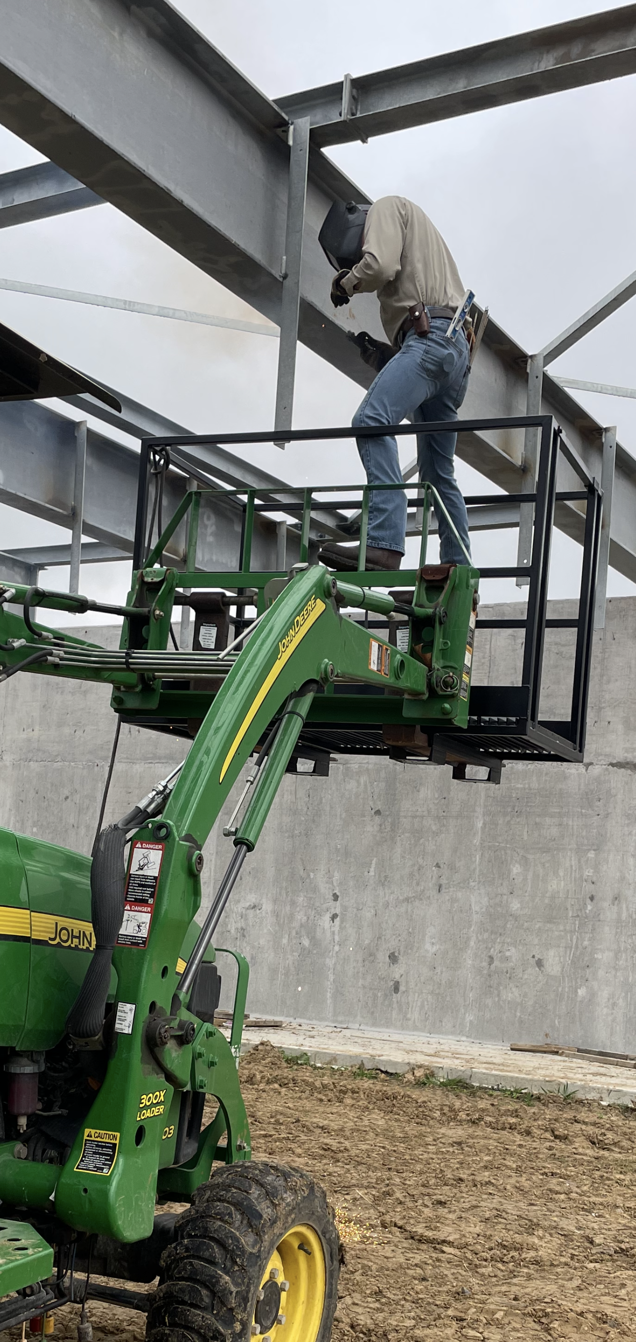 There is a gate in the middle of a brick wall.