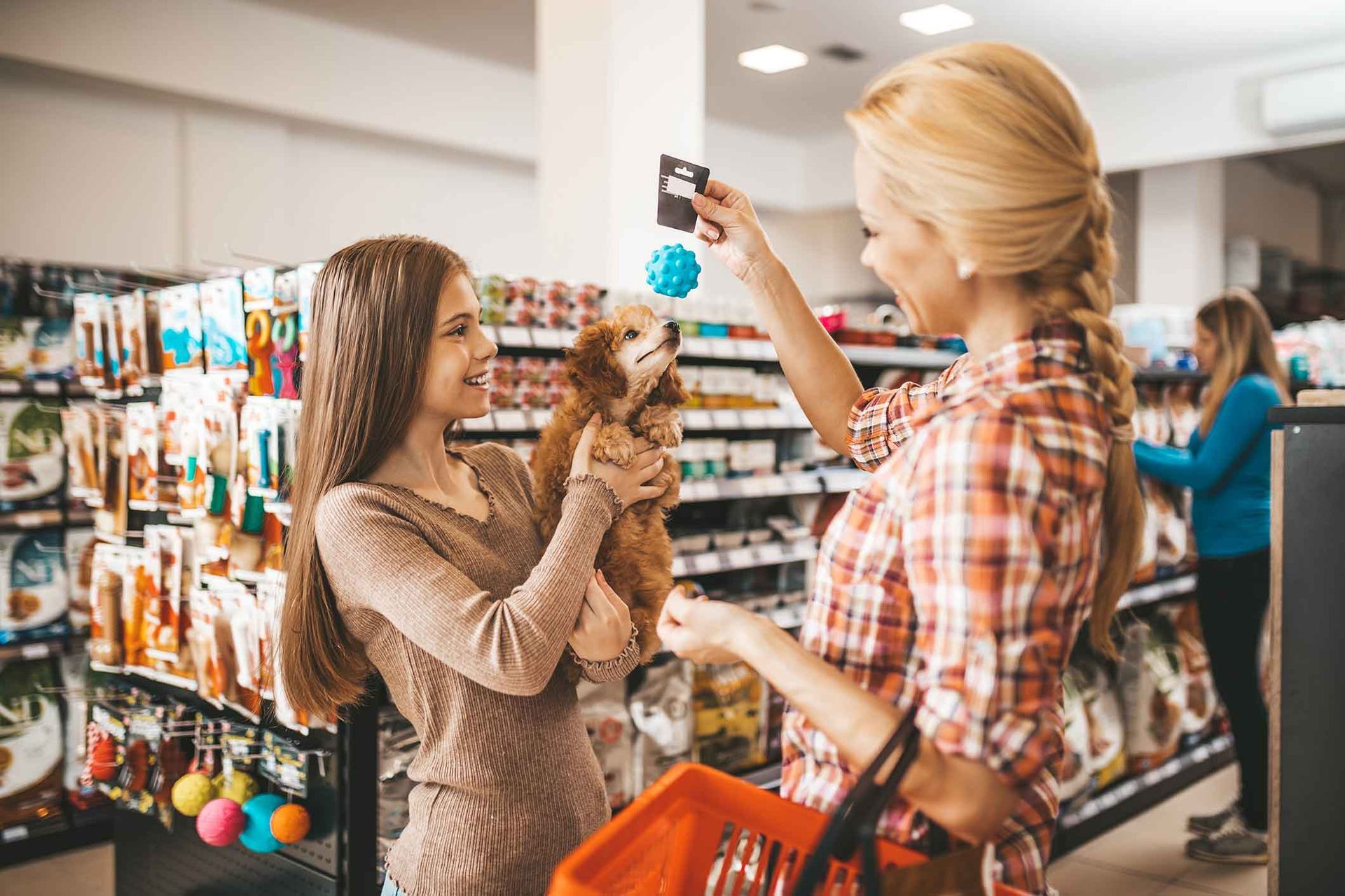 Mom and daughter at a pet shop with their dog.