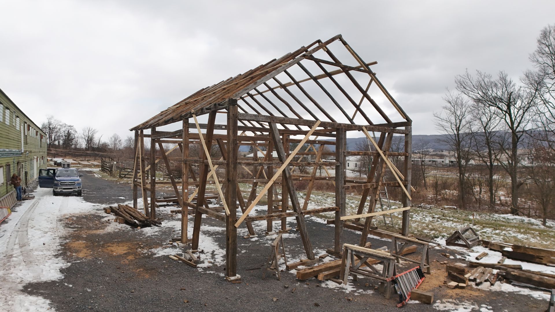 The inside of an old wooden barn filled with hay.