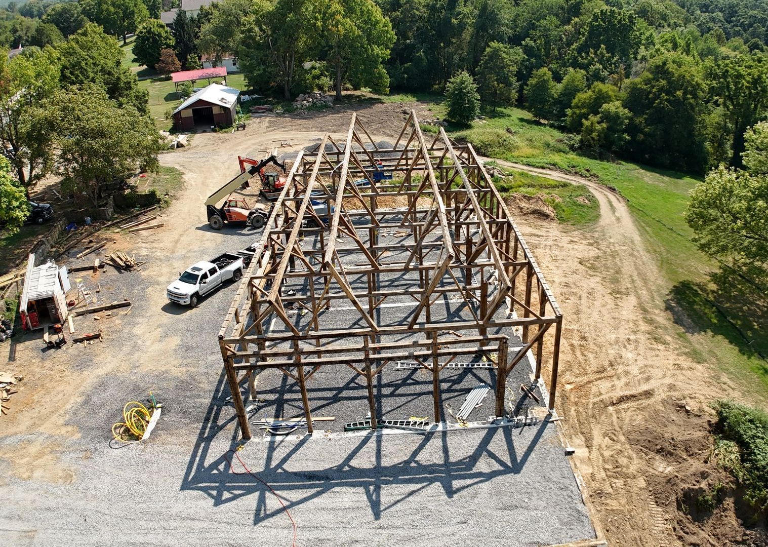 An aerial view of a building under construction in a field.