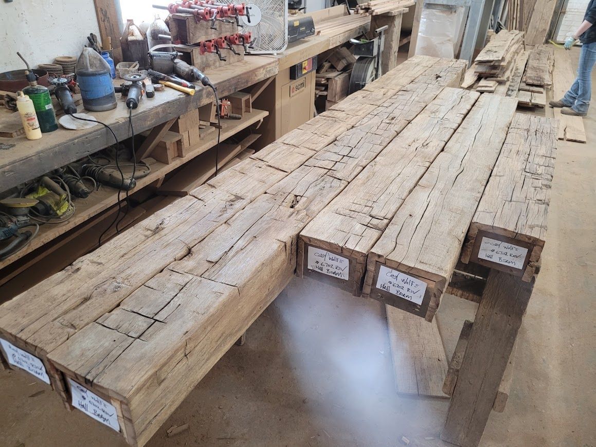 Stacked preserved antique frames in a workshop.