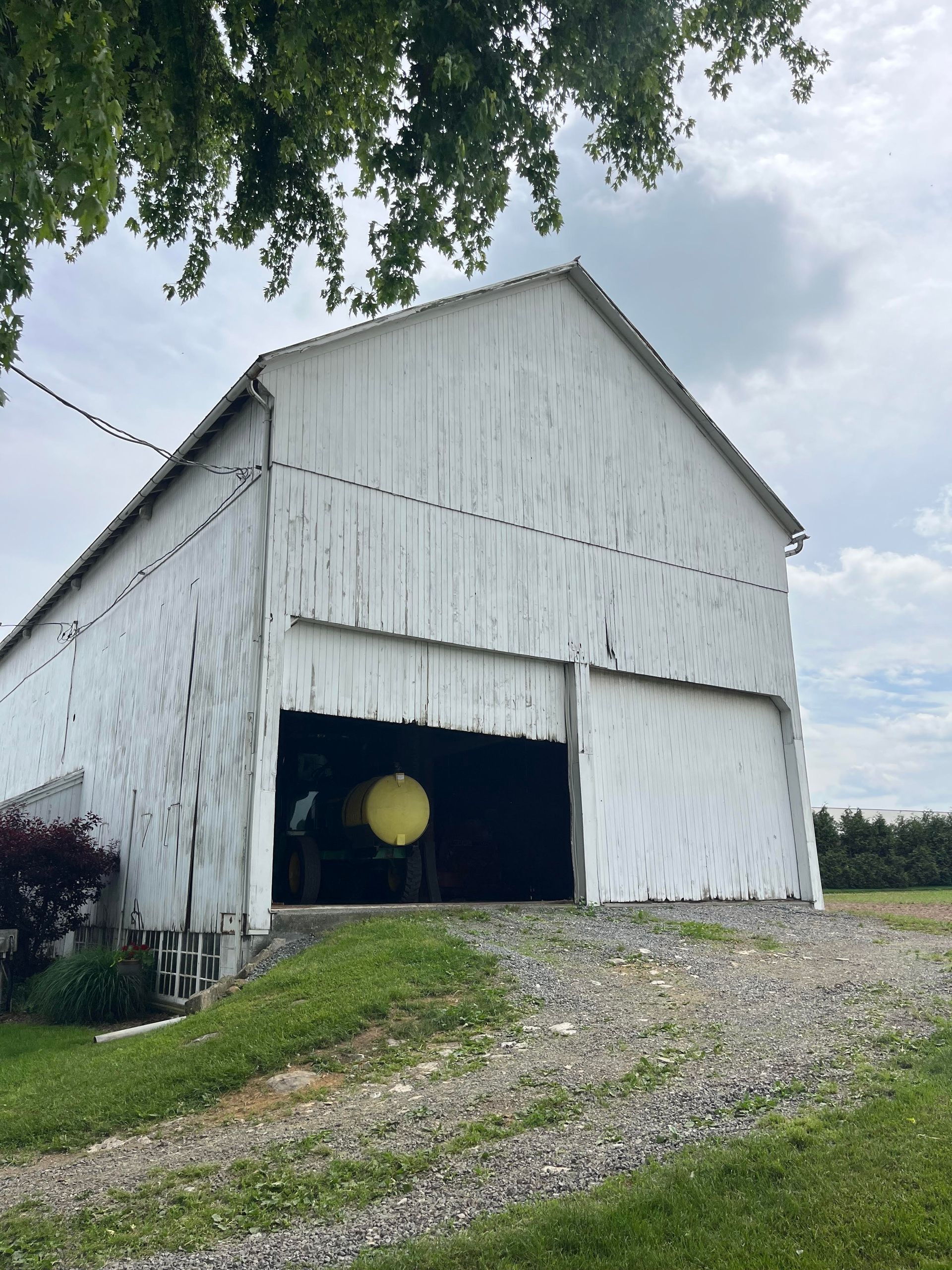 White rustic barn with open doors in Pennsylvania, ideal for wedding venue inspiration.