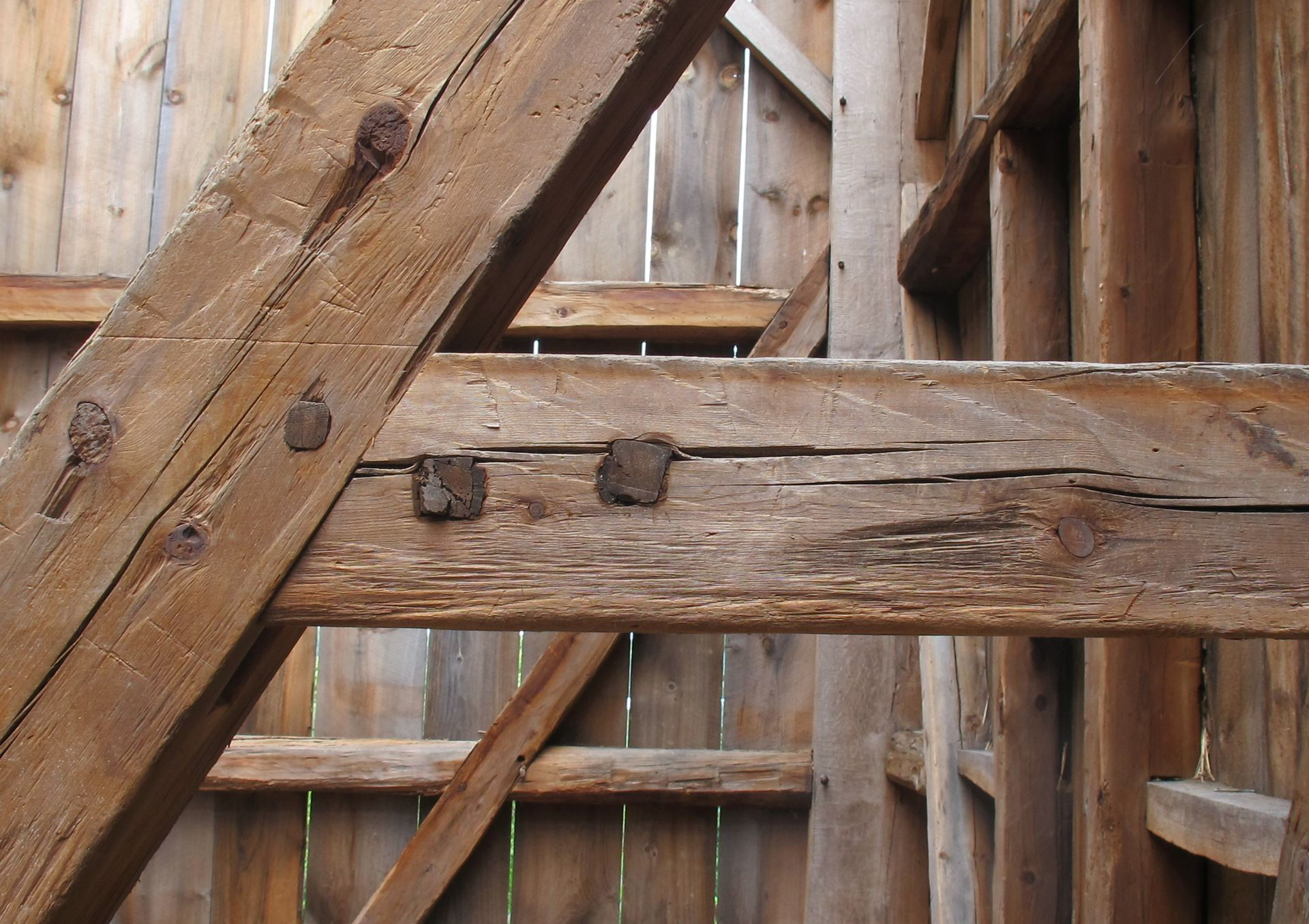 Timber frame joint secured with drawboring pegs.