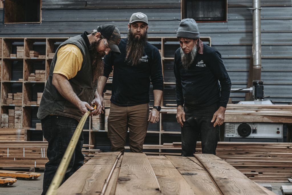 Craftsmen Measuring a Table Made from Heritage Reclaimed Wood in Pennsylvania