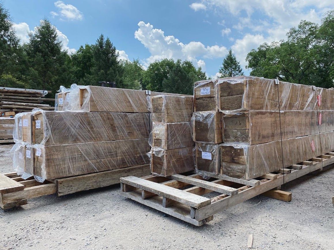 Stacked wooden beams prepared for heavy timber construction.