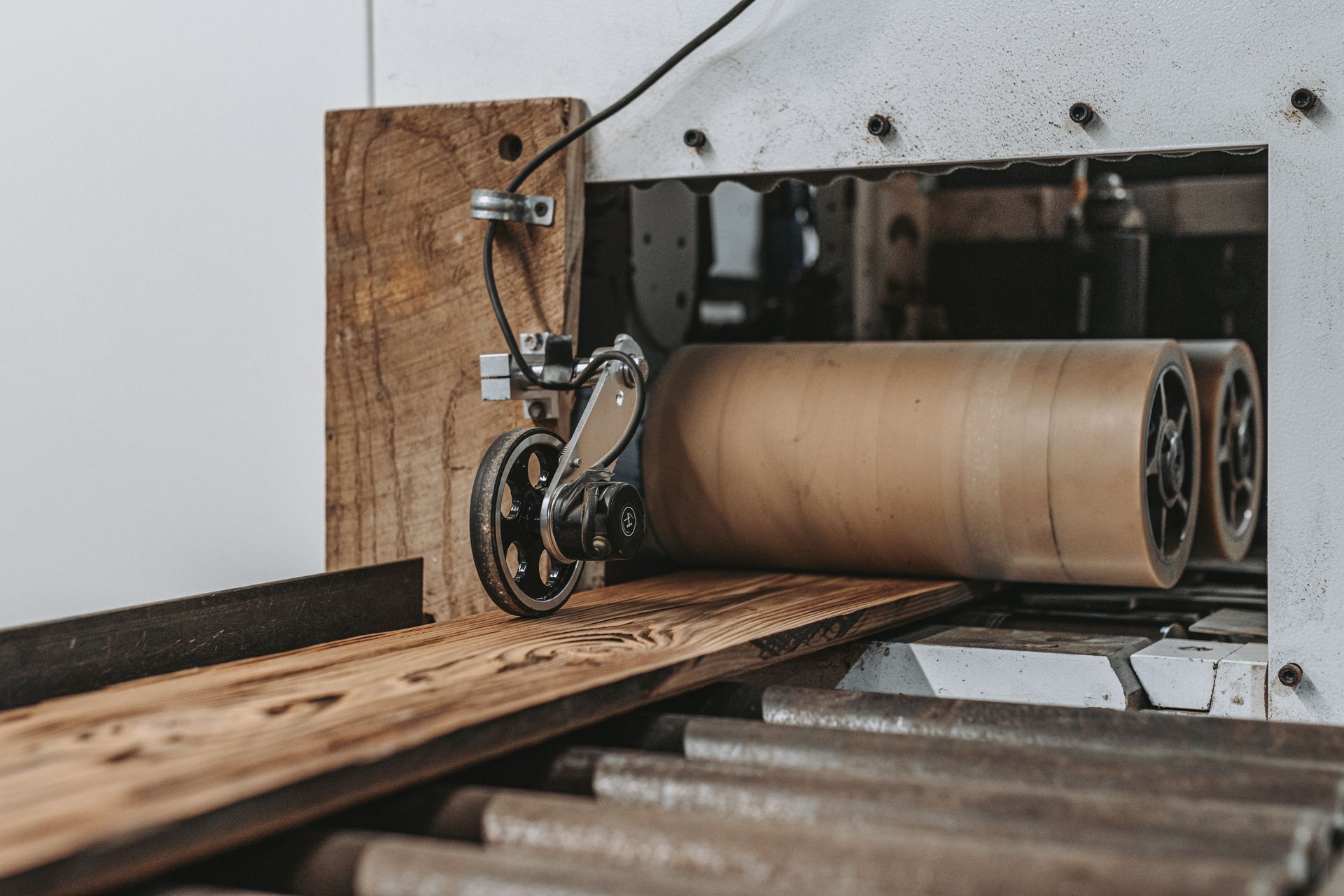 Close-up of a woodworking machine processing a board for wood recycling.