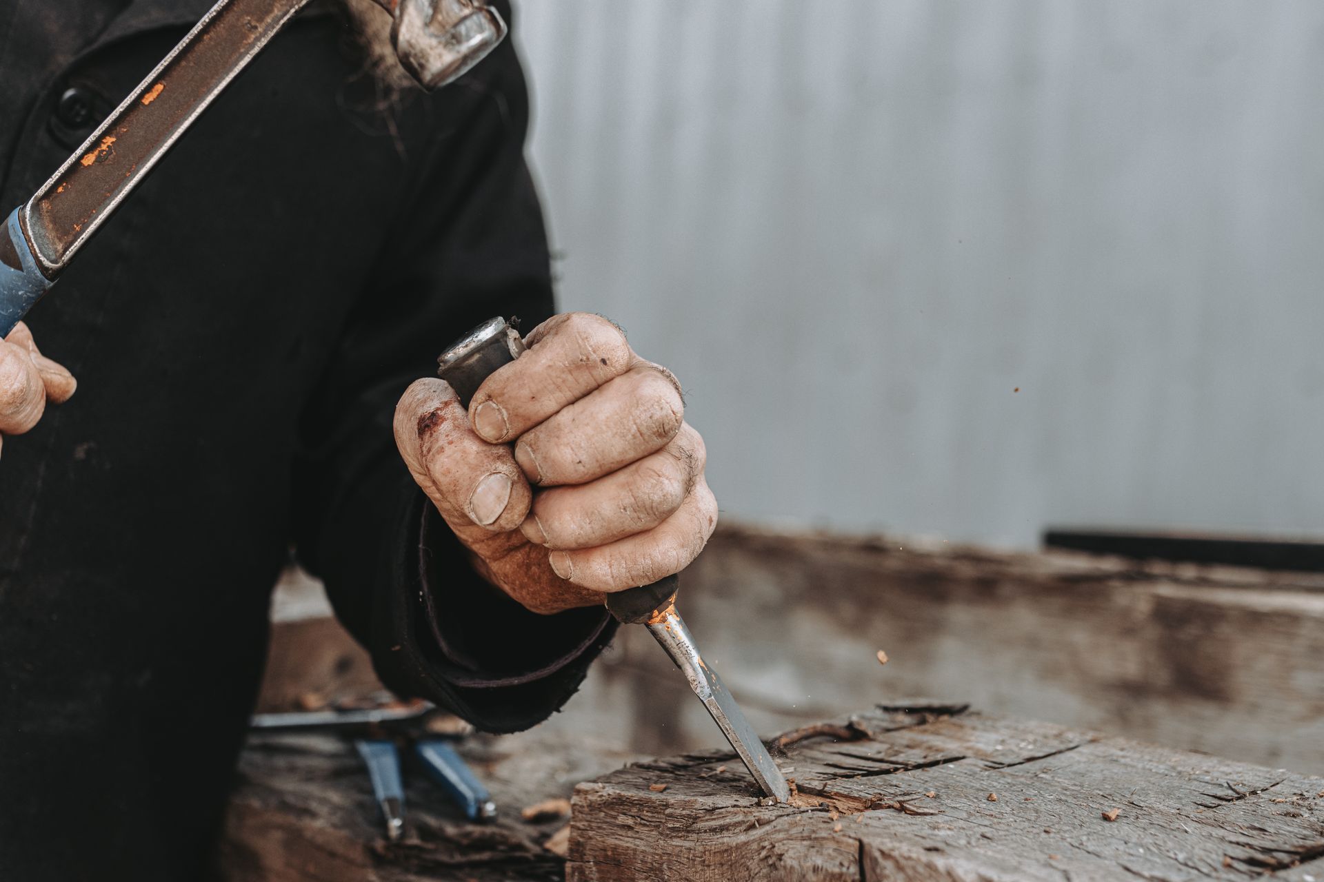 Pennsylvania craftsman chiseling wood to shape butterfly keys for rustic furniture and joinery.
