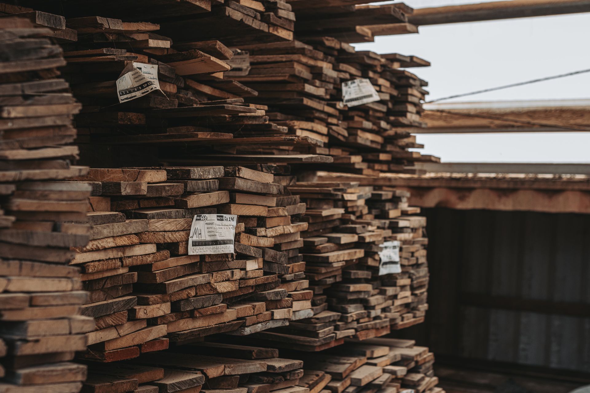 Stacks of wooden planks prepared for historic timber reuse projects.