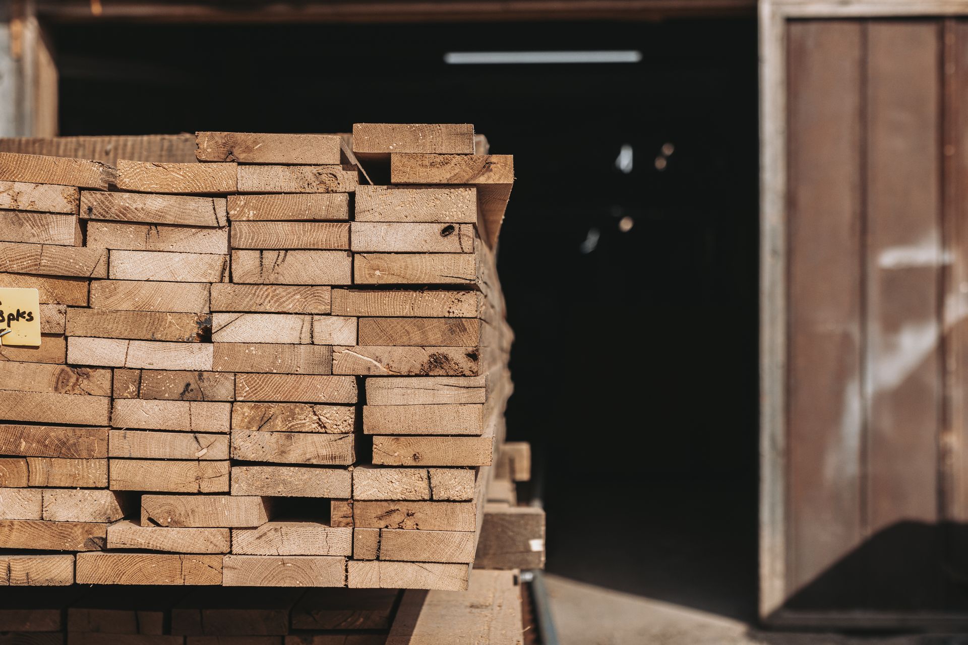 Stack of wooden planks for timber frame construction.