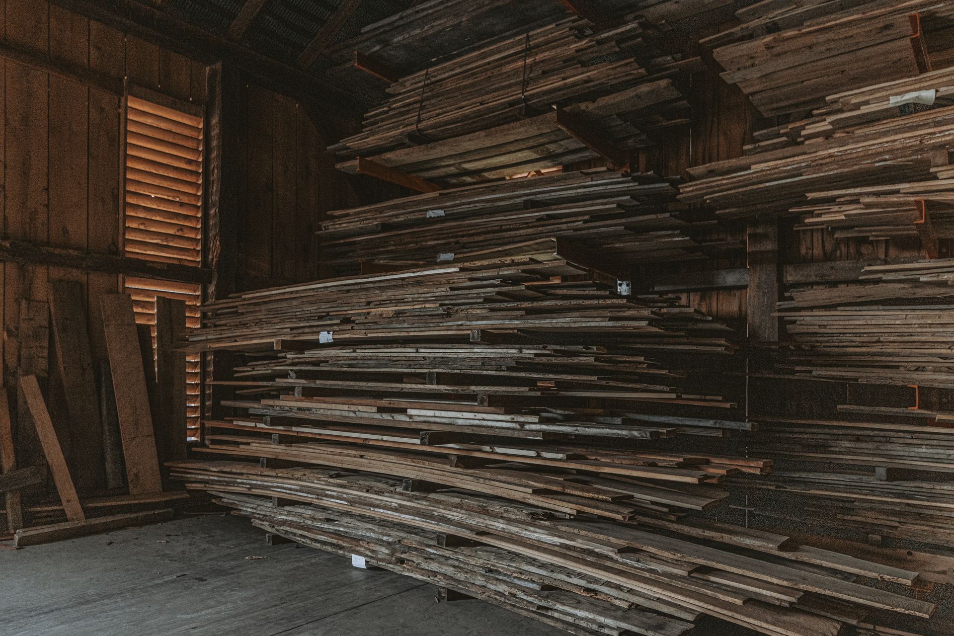 Stacks of aged wooden planks and vintage building materials for restoration projects.