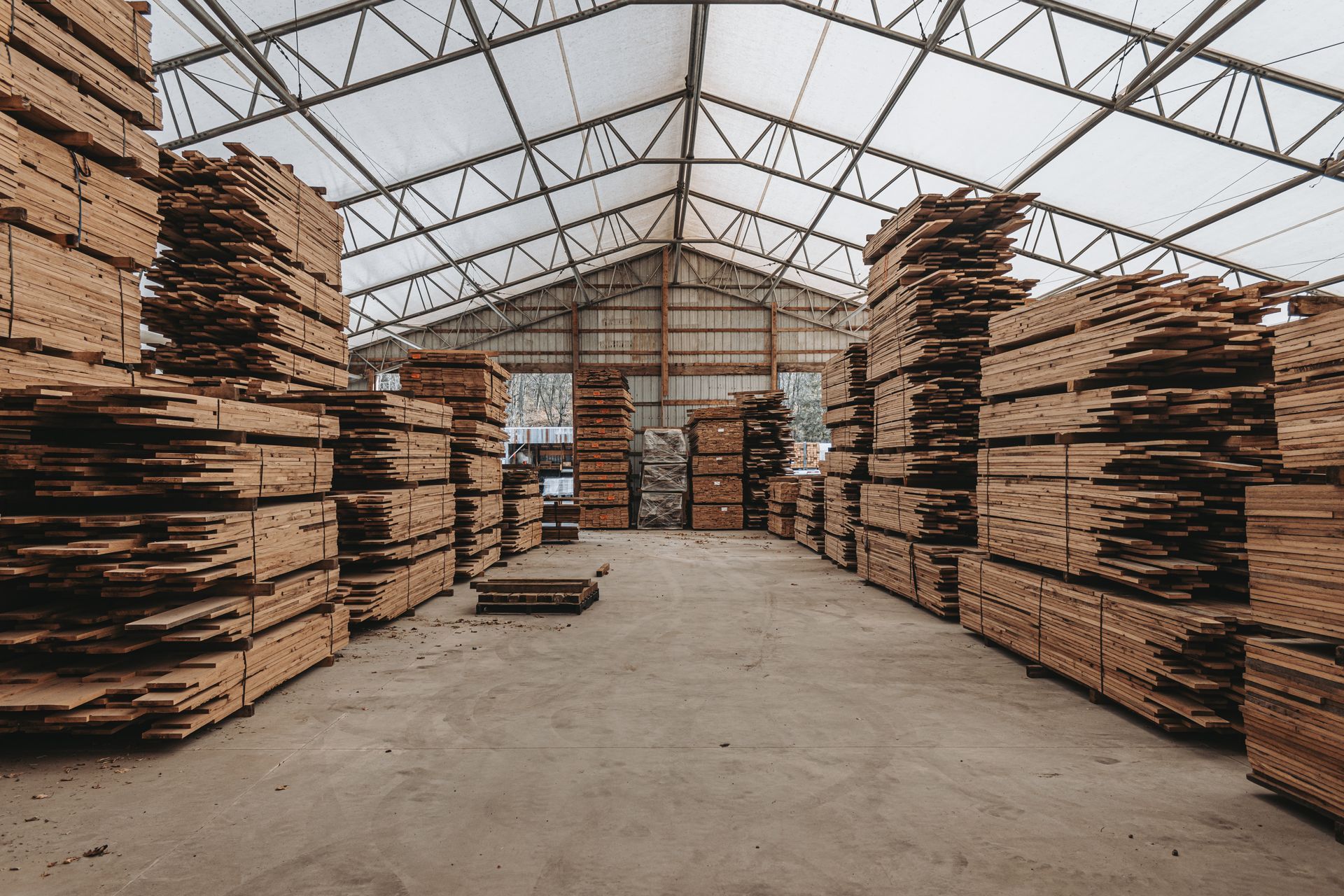 The inside of an old wooden barn filled with hay.