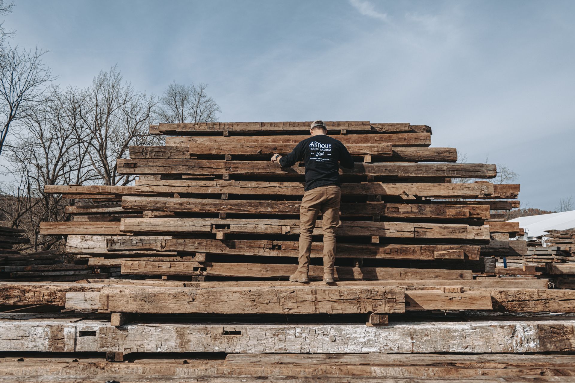 A stack of reclaimed, barn wood, organized for reerection as a home or event space in Pennsylvania