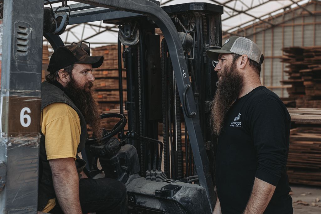 Workers in a Pennsylvania Lumberyard Discussing Traditional Barn Construction