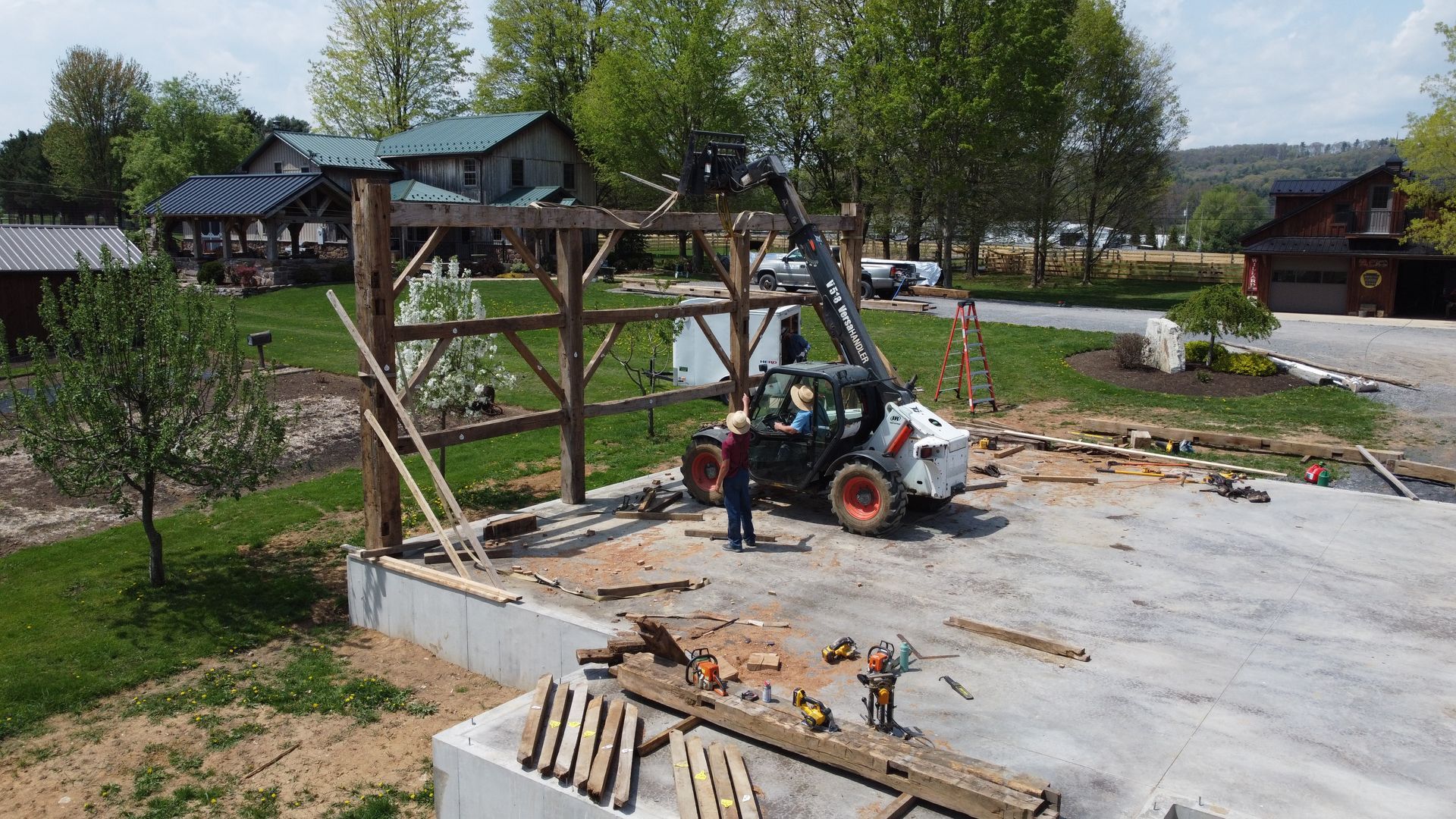 Bay & Bent America men assembling a timber frame structure using architectural timber joinery
