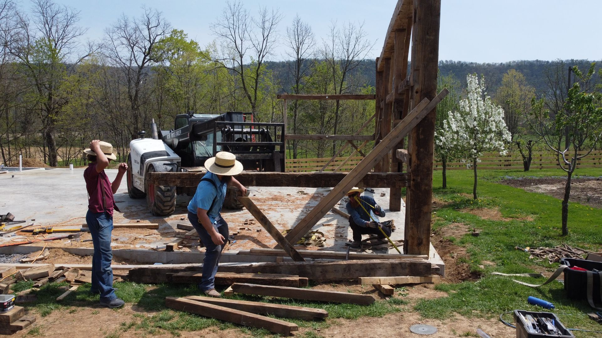 Workers construct a timber frame, showcasing architectural restoration.
