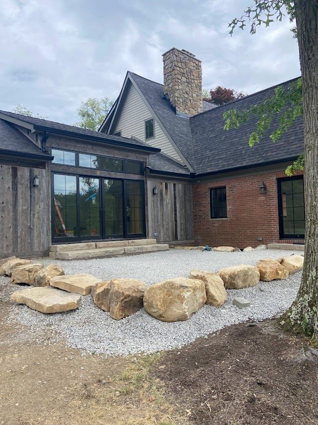 A Barndominium with wood, brick, and stone design.
