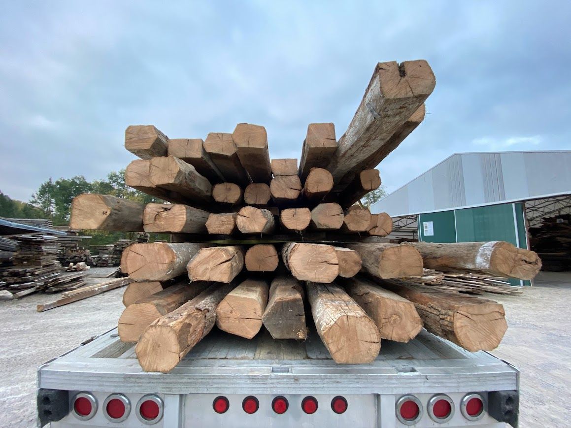 Stack of wooden logs in Pennsylvania showing end check cracks that reveal natural aging process.