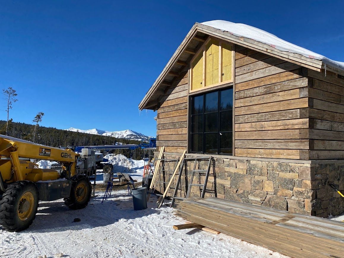 Snowy Construction Site with Reclaimed Wood Wall and Stone Foundation in Pennsylvania