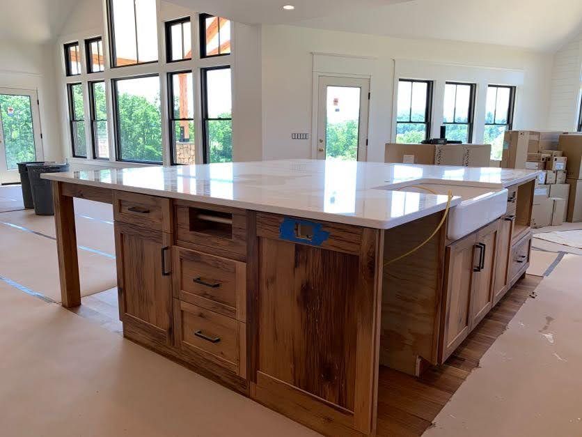 Modern kitchen with restored timber frames and island.
