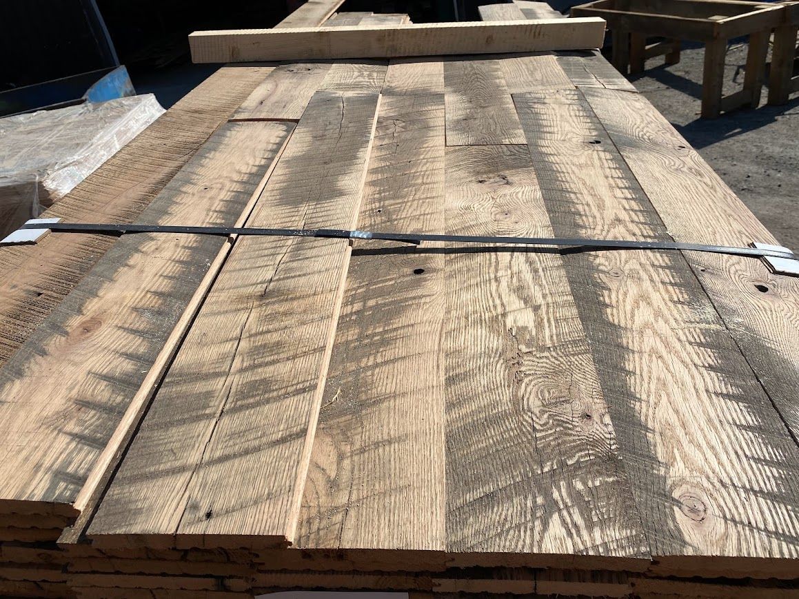 Stacked wooden planks to acclimate lumber outdoors.