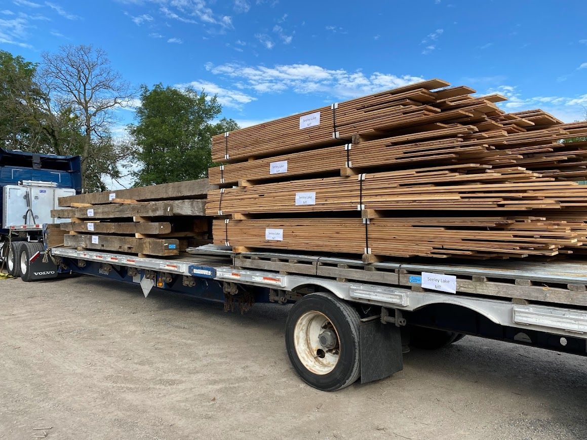 A truck transporting lumber from historic barn frame suppliers.