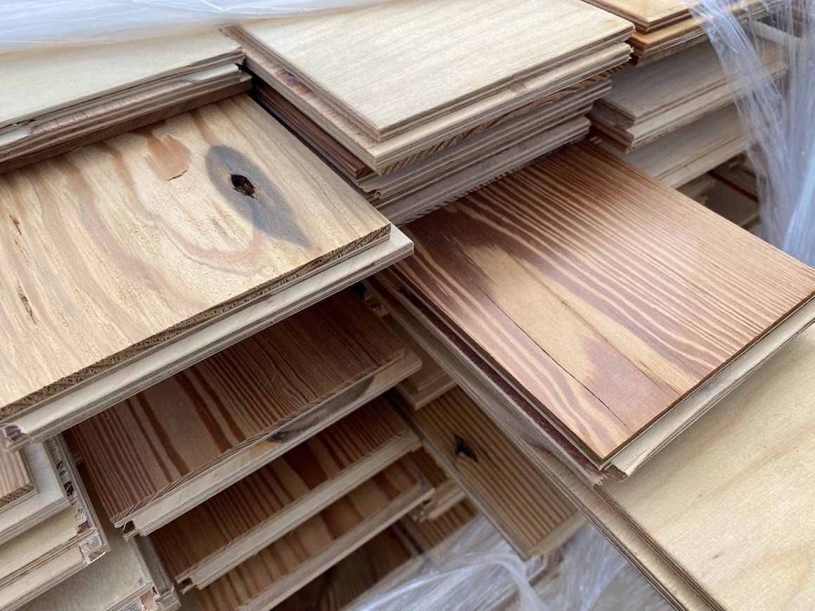 Stacks of wooden planks with visible wood filler.