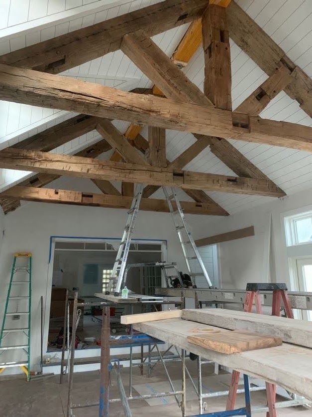 Interior construction with wooden timber trusses and scaffolding.