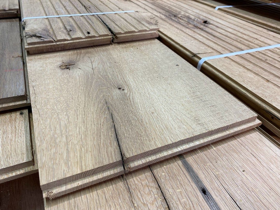 Stacks of wooden boards showing end check cracks.