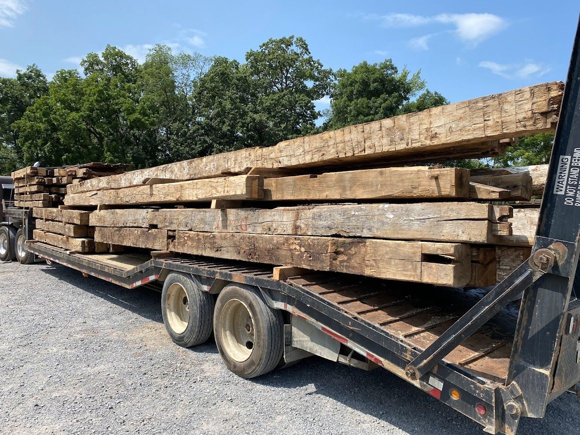 Flatbed trailer loaded with reclaimed timber from sustainable dismantling.