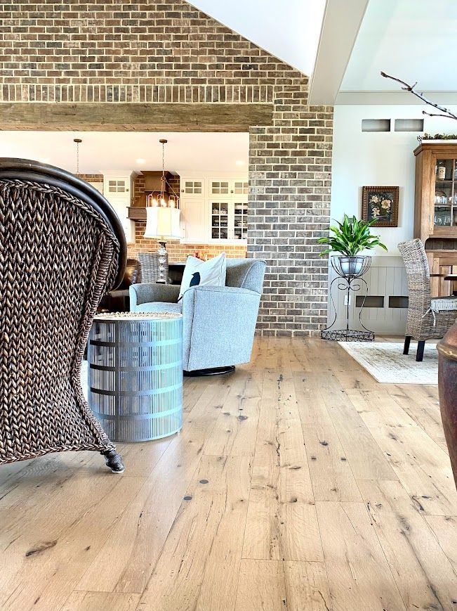 Living Area with Reclaimed Wood Flooring and Exposed Brick Wall in Pennsylvania