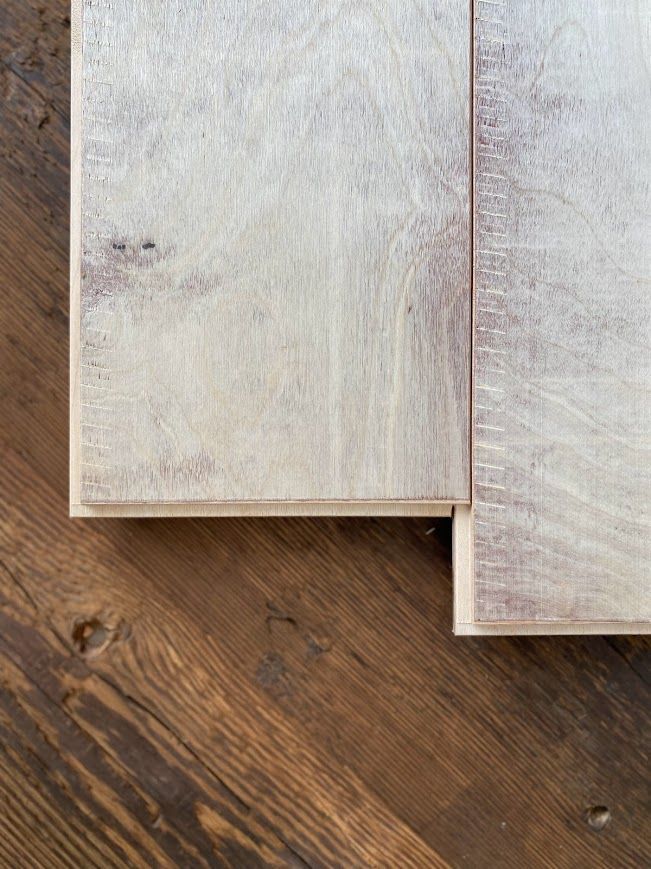 Glue laminated beams on rustic wooden background.